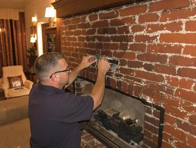 Norwalk Chimney Sweep expert fixing a fireplace in Norwalk, CT